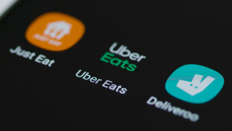 Close-Up-Shot-of-a-Finger-Tapping-the-Uber-Eats-App-On-Smartphone-