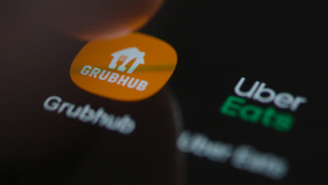 Close-Up-Shot-of-a-Finger-Tapping-the-Grubhub-App-On-a-Smartphone-Screen