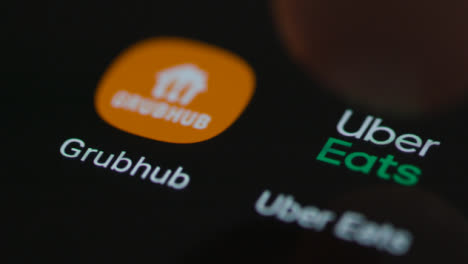 Close-Up-Shot-of-Finger-Tapping-the-Uber-Eats-App-On-a-Smartphone-