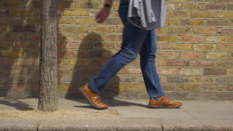 Medium-Shot-of-Persons-Feet-Walking-Down-Street