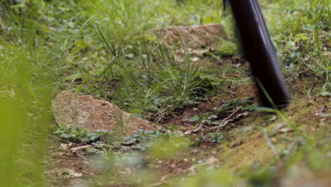 Close-Up-Of-Man-On-Mountain-Bike-Cycling-Along-Grass-Trail-Through-Woodland-2