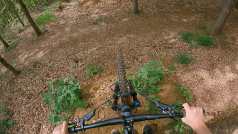 POV-Shot-Of-Man-On-Mountain-Bike-Doing-Mid-Air-Jumps-On-Trail-Through-Woodland-4
