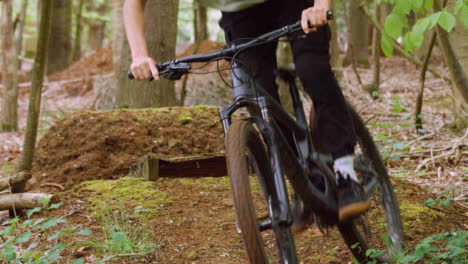 Slow-Motion-Shot-Of-Man-On-Mountain-Bike-Making-Mid-Air-Jump-On-Dirt-Trail-Through-Woodland-15