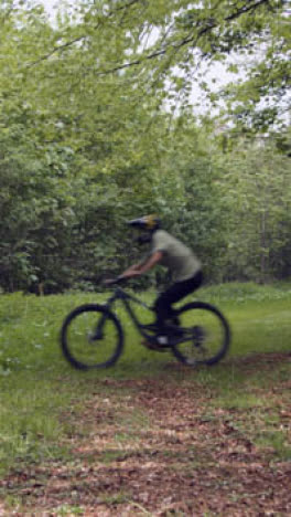 Vertical-Video-Of-Man-On-Mountain-Bike-Cycling-Along-Dirt-Trail-Through-Woodland-6