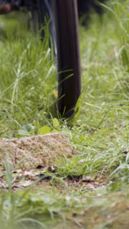 Close-Up-Vertical-Video-Of-Man-On-Mountain-Bike-Cycling-Along-Dirt-Trail-Through-Woodland-