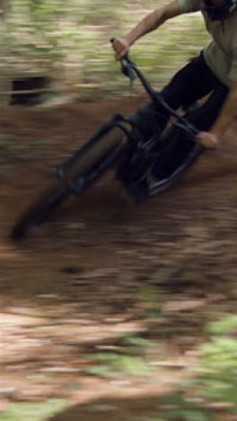 Vertical-Video-Of-Man-On-Mountain-Bike-Cycling-Along-Dirt-Trail-Through-Woodland-8