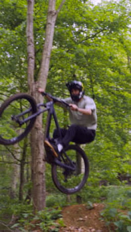 Vertical-Video-Of-Man-On-Mountain-Bike-Cycling-Along-Dirt-Trail-Through-Woodland-11