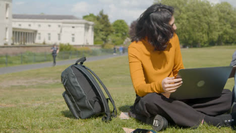 Handheld-Shot-of-Student-Working-In-a-Park