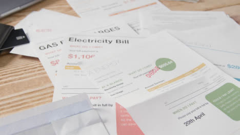 Close-Up-Of-Person-Opening-Overdue-US-Energy-Bill-Pile-Utility-Debts