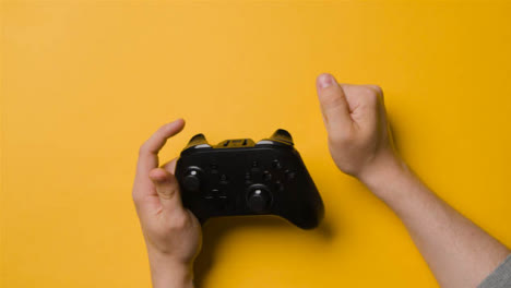 Overhead-Studio-Hands-Playing-Video-Game-Controller-Frustrated-And-Losing-2