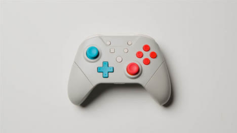 Overhead-Studio-Shot-Of-Hand-Reaching-In-To-Pick-Up-Video-Game-Controller-11