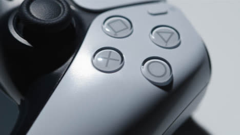 Studio-Close-Up-Of-Video-Game-Controller-Rotating-Past-Camera-On-White-Background-3