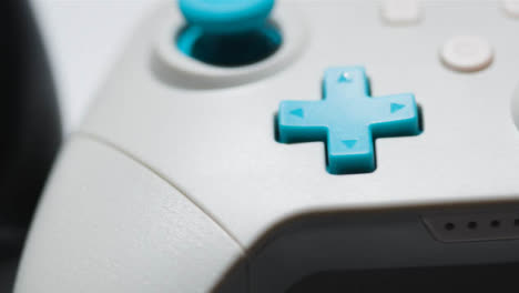 Studio-Close-Up-Of-Two-Video-Game-Controllers-Rotating-White-Background