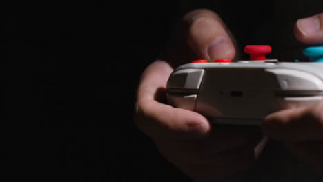 Side-On-Close-Up-Hands-Man-Playing-Video-Game-Controller-Low-Light-Background-2