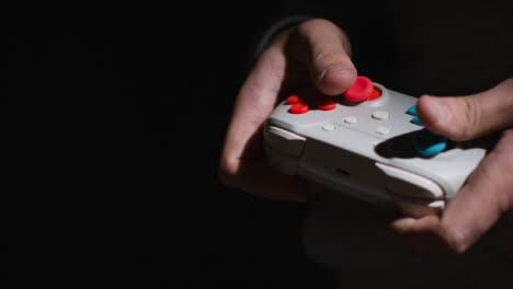 Side-On-Close-Up-Hands-Man-Playing-Video-Game-Controller-Low-Light-Background-3