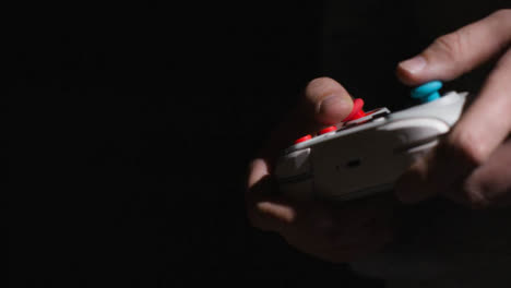 Side-On-Close-Up-Hands-Man-Playing-Video-Game-Controller-Low-Light-Background-4