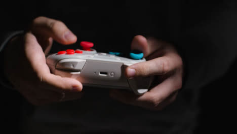 Front-On-Close-Up-Hands-Man-Playing-Video-Game-Controller-Low-Light-Background-1