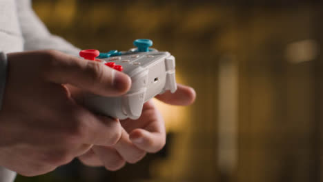 Side-On-Close-Up-Shot-Of-Hands-As-Man-Plays-With-Video-Game-Controller-At-Home