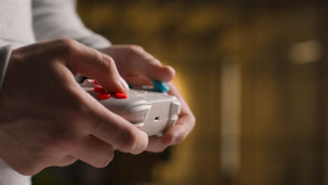 Side-On-Close-Up-Hands-As-Man-Plays-With-Video-Game-Controller-At-Home-2