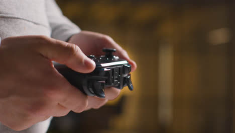 Side-On-Close-Up-Hands-As-Man-Plays-With-Video-Game-Controller-At-Home-4