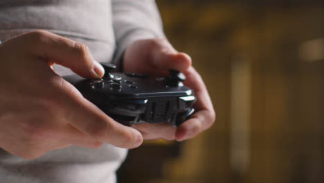 Side-On-Close-Up-Hands-As-Man-Plays-With-Video-Game-Controller-At-Home-5