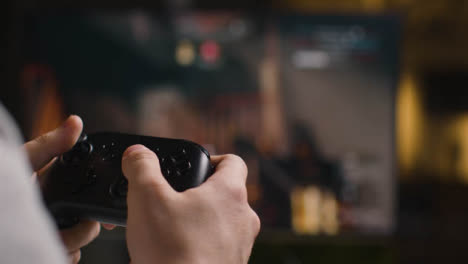 Close-Up-Shot-Hands-Man-Playing-Video-Game-Controller-Screen-In-Background-1