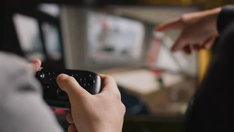Close-Up-Hands-Friends-Playing-Shooting-Video-Game-Controller-Screen-Background
