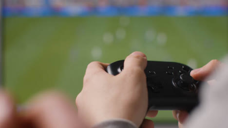 Close-Up-Hands-Friends-Playing-Sports-Video-Game-Controller-Screen-Background-1