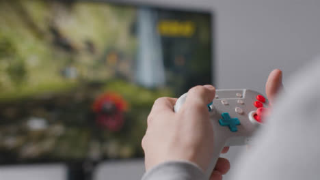 Close-Up-Hands-Man-Playing-Video-Game-Controller-Screen-In-Background-3