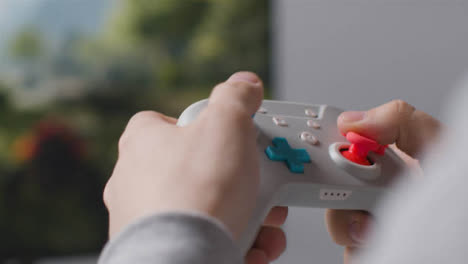 Close-Up-Hands-Man-Playing-Video-Game-Controller-Screen-In-Background-4