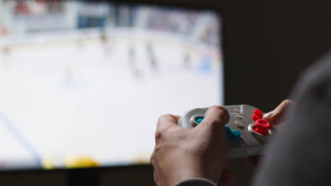 Close-Up-Hands-Man-Playing-Sports-Video-Game-Controller-Screen-Background-2