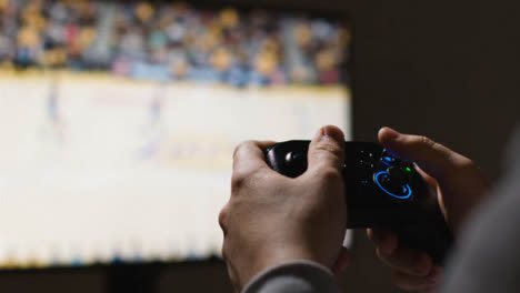 Close-Up-Hands-Man-Playing-Sports-Video-Game-Controller-Screen-Background-6