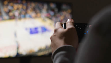Close-Up-Hands-Man-Playing-Sports-Video-Game-Controller-Screen-Background-7
