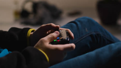 Side-On-Close-Up-Hands-Man-Playing-Video-Game-Controller-Sitting-Sofa-At-Home-2