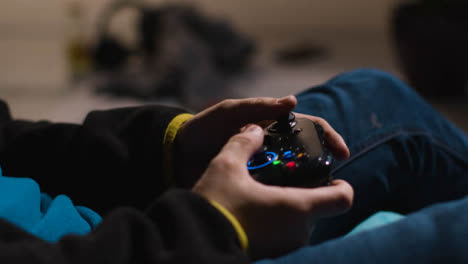 Side-On-Close-Up-Hands-Man-Playing-Video-Game-Controller-Sitting-Sofa-At-Home-4