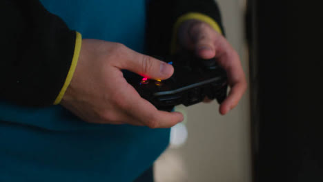 Side-On-Close-Up-Hands-Man-Standing-Playing-Video-Game-Controller-At-Home