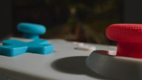 Close-Up-Macro-Video-Game-Controller-Shooting-Game-On-Screen-In-Background