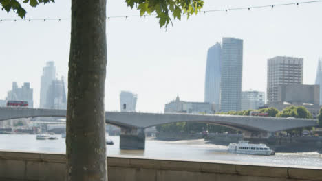 Cyclists-In-Cycle-Lane-Commuting-To-Work-On-The-Embankment-With-City-Skyline-1