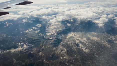 Ansicht-Flugzeug-Fenster-Schneebedeckte-Berge-Winter-Skigebiet-Urlaub-Urlaub