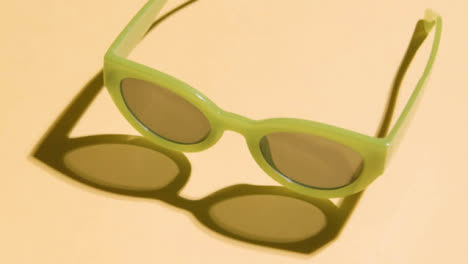 Summer-Holiday-Vacation-Concept-Of-Green-Sunglasses-On-Yellow-Background-3