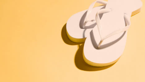 Summer-Holiday-Vacation-Concept-Of-Flip-Flops-Sandals-On-Yellow-Background-3