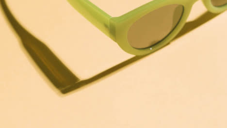 Summer-Holiday-Vacation-Concept-Of-Sunglasses-On-Yellow-Background-Close-Up-1