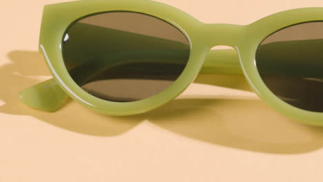 Summer-Holiday-Vacation-Concept-Of-Sunglasses-On-Rotating-Yellow-Background-2