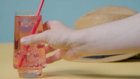 Summer-Holiday-Concept-Of-Cold-Drink-With-Sun-Hat-On-Beach-Towel-2