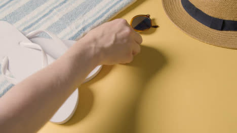 Summer-Holiday-Of-Concept-Sun-Hat-Sunglasses-Flip-Flops-On-Beach-Towel-2