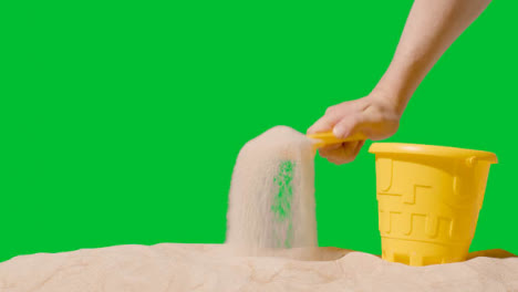 Summer-Holiday-Concept-With-Child's-Bucket-Spade-On-Sandy-Beach-Against-Green-Screen-5