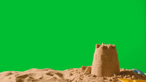 Summer-Holiday-Concept-Making-Sandcastle-On-Sandy-Beach-Against-Green-Screen-2