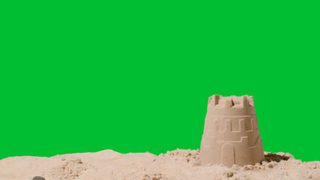 Summer-Holiday-Concept-Making-Sandcastle-On-Sandy-Beach-Against-Green-Screen-7