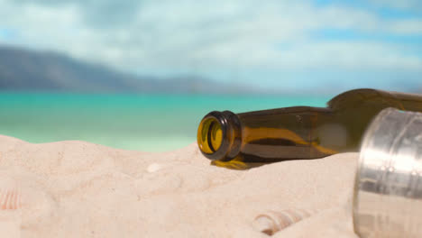 Pollution-Concept-With-Bottles-And-Rubbish-On-Beach-Against-Sea-Background-1