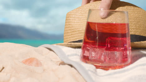 Concepto-De-Vacaciones-De-Verano-De-Bebida-Fría-En-Toalla-De-Playa-Con-Sombrero-Para-El-Sol-Contra-El-Fondo-Del-Mar-2